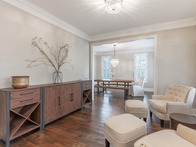 sitting room featuring crown molding, dark hardwood / wood-style floors, and a chandelier