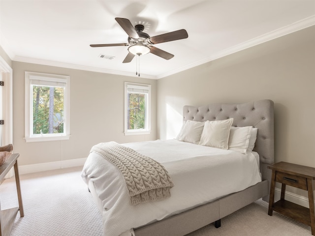 carpeted bedroom featuring crown molding, ceiling fan, and multiple windows