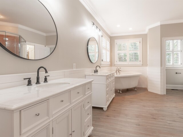 bathroom with vanity, a bathtub, crown molding, and hardwood / wood-style flooring