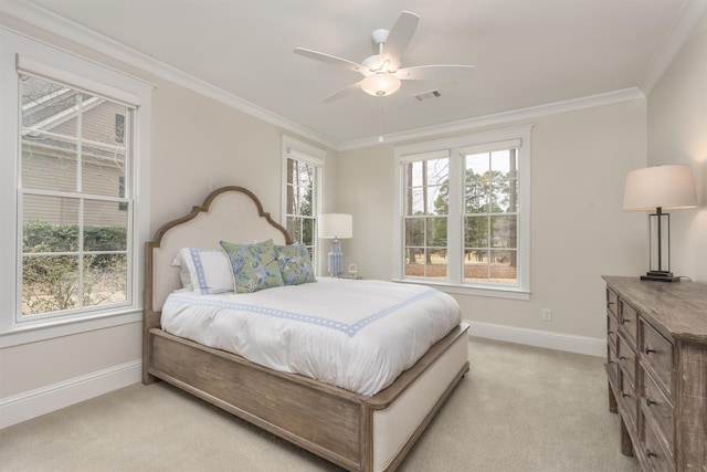 carpeted bedroom with ceiling fan and ornamental molding