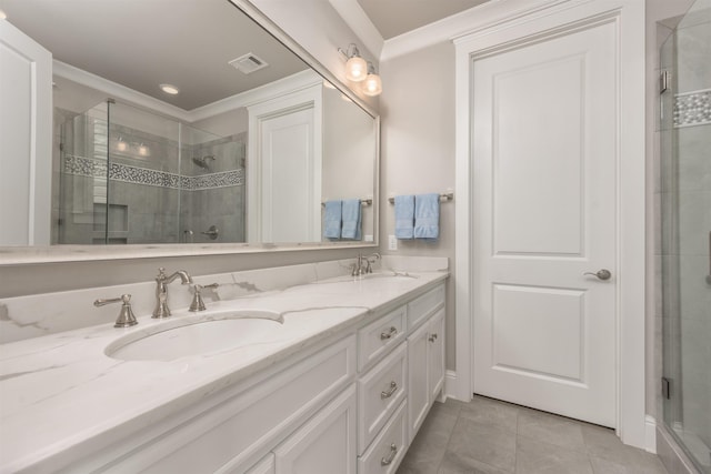 bathroom featuring crown molding, tile patterned floors, a shower with shower door, and vanity