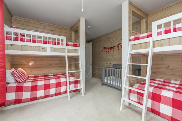 carpeted bedroom with wood walls