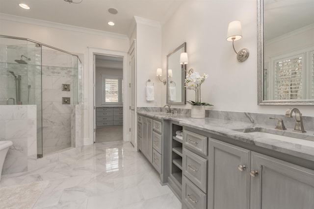 bathroom with ornamental molding, vanity, and a shower with shower door