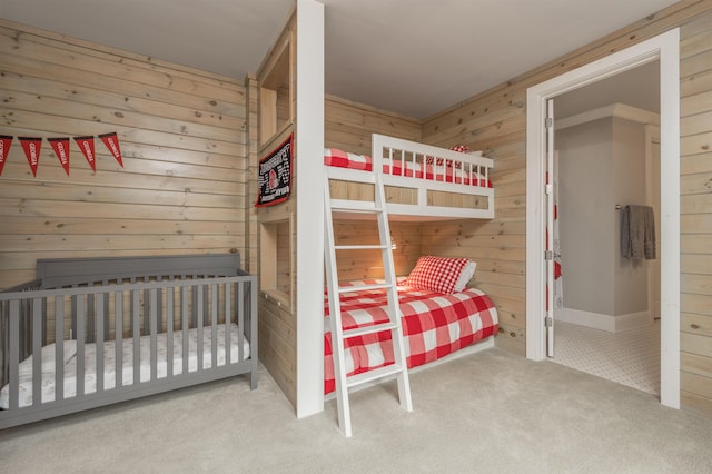 bedroom with carpet flooring and wood walls