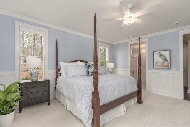 carpeted bedroom with ceiling fan, ornamental molding, and connected bathroom