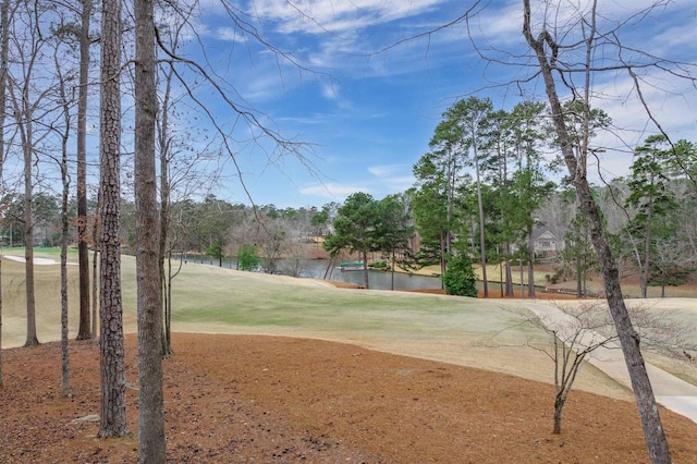 surrounding community featuring a water view and a lawn