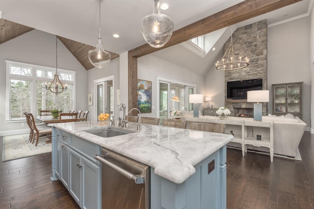 kitchen with sink, a chandelier, hanging light fixtures, a center island with sink, and dishwasher