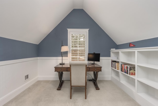 office area featuring light carpet and vaulted ceiling