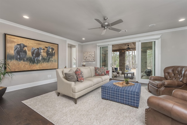 living room with dark hardwood / wood-style flooring, crown molding, and ceiling fan