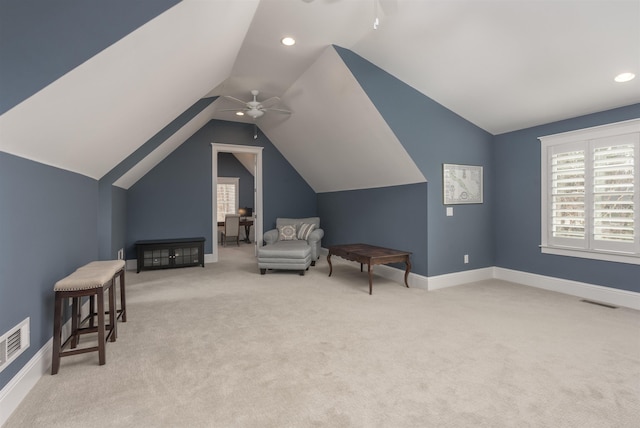 sitting room with light carpet, vaulted ceiling, and ceiling fan