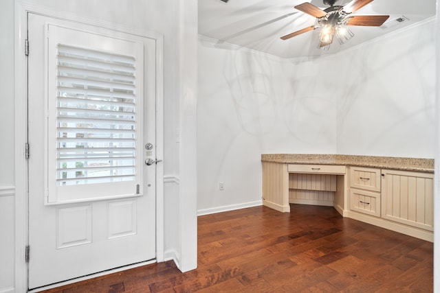 entryway with built in desk, ornamental molding, dark hardwood / wood-style floors, and ceiling fan