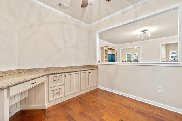 interior space with hardwood / wood-style flooring, ceiling fan, and crown molding