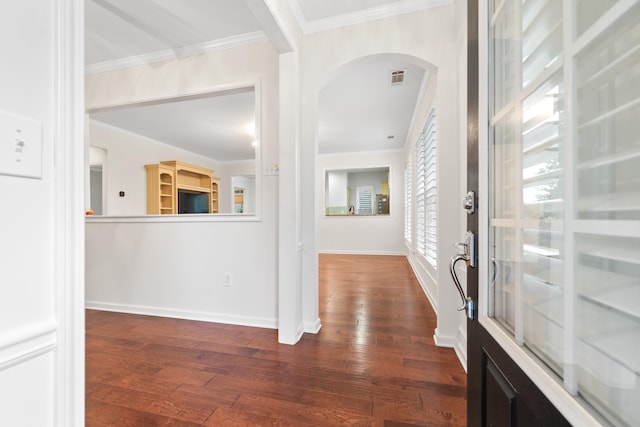 foyer with dark wood-type flooring and ornamental molding