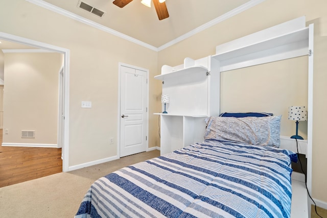 bedroom with crown molding, carpet flooring, and ceiling fan