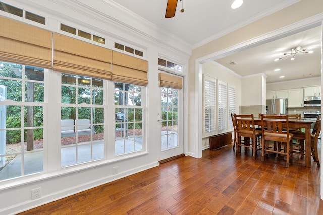 dining space with ornamental molding, dark wood-type flooring, and ceiling fan