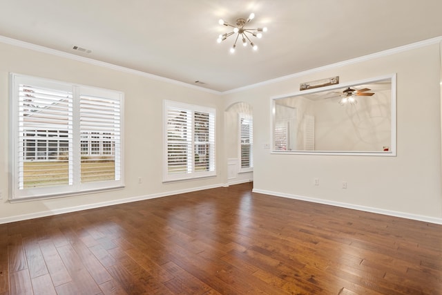 spare room featuring crown molding, dark hardwood / wood-style floors, and ceiling fan with notable chandelier