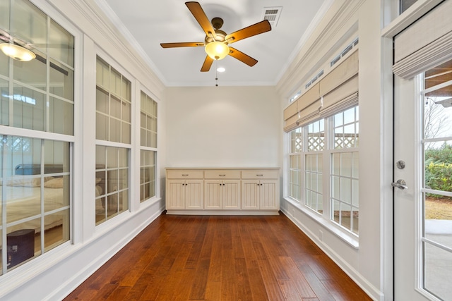 unfurnished sunroom featuring ceiling fan