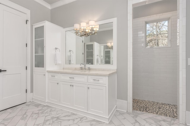 full bath with marble finish floor, ornamental molding, vanity, a walk in shower, and a chandelier