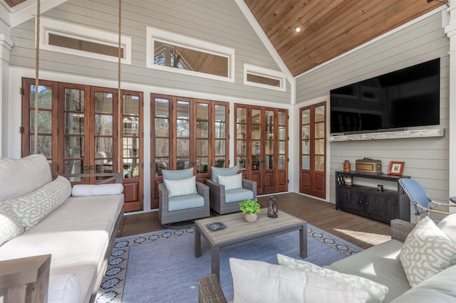 living room featuring high vaulted ceiling, wooden ceiling, wooden walls, and wood finished floors