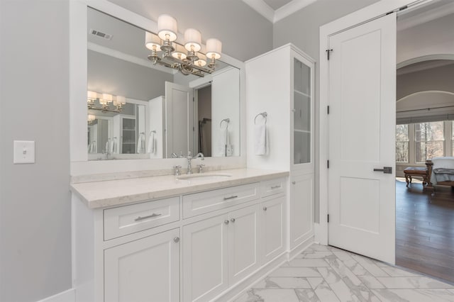 bathroom with a notable chandelier, vanity, visible vents, marble finish floor, and crown molding