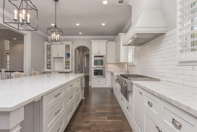 kitchen with stainless steel appliances, open shelves, white cabinets, and custom range hood