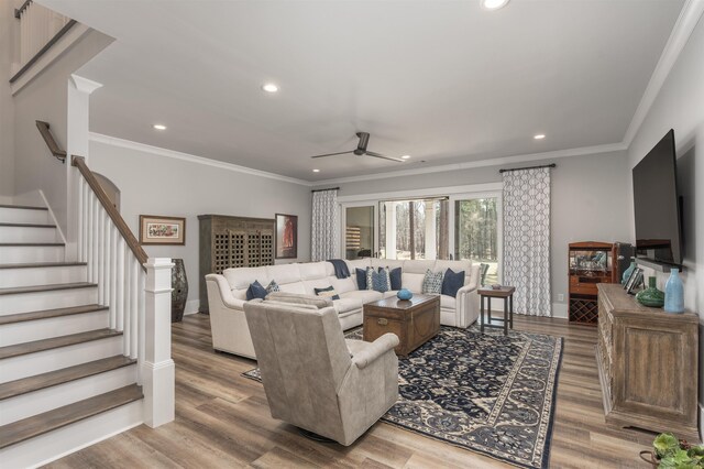 living area featuring stairs, ornamental molding, wood finished floors, and recessed lighting