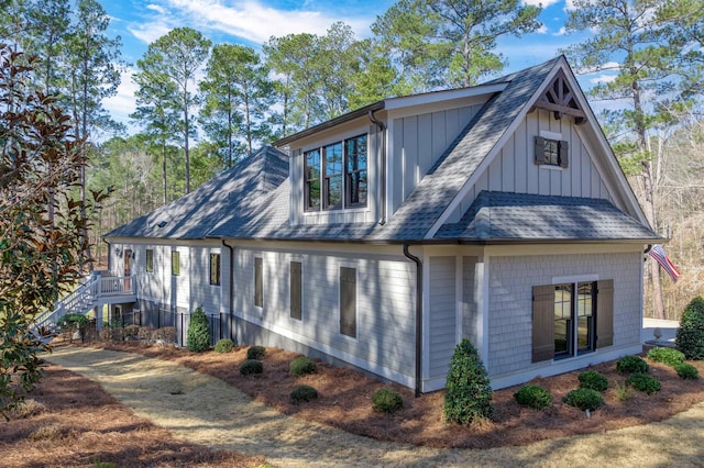 view of property exterior featuring a shingled roof and board and batten siding