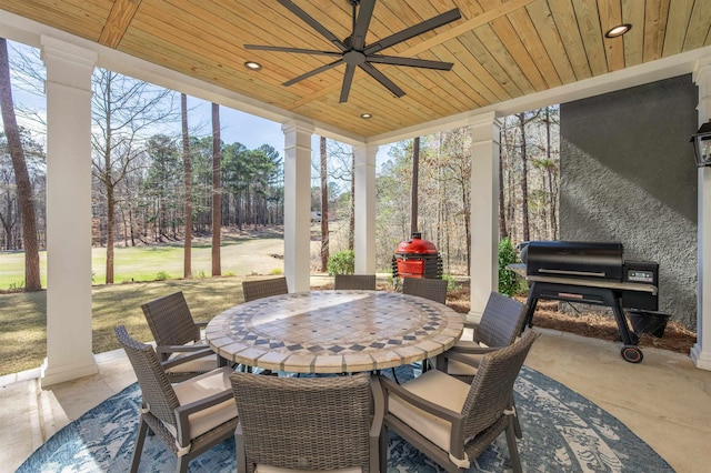 view of patio featuring grilling area, outdoor dining area, and a ceiling fan