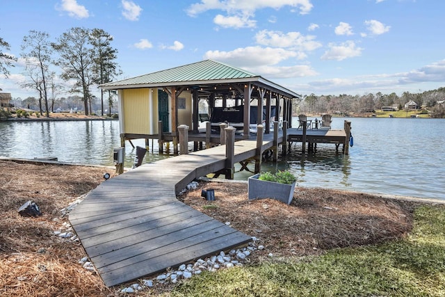 dock area with boat lift and a water view