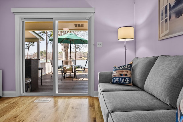 interior space featuring wood finished floors, visible vents, and baseboards