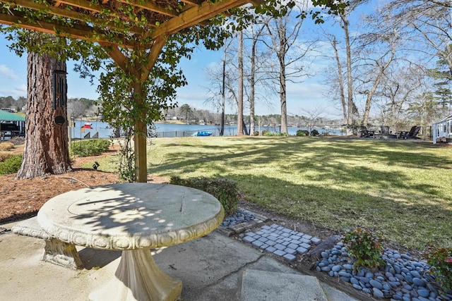 view of yard with a water view and a patio area