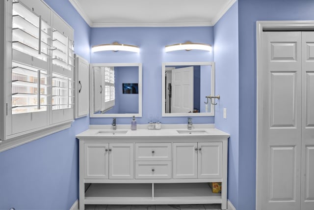 full bath featuring crown molding, double vanity, and a sink