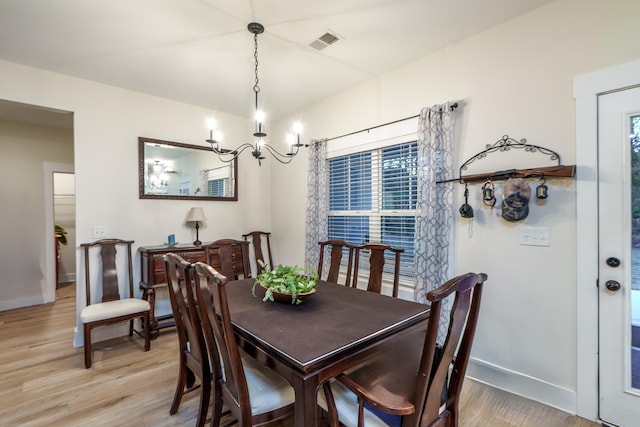 5761 Dixie Hwy, Rutledge, GA 30663 - dining area with a chandelier, light wood-style flooring, and baseboards