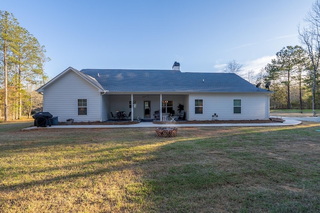 5761 Dixie Hwy, Rutledge, GA 30663 - rear view of house featuring a patio area, a lawn, a chimney, and a shingled roof