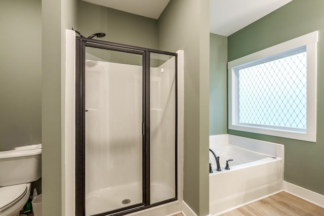 5761 Dixie Hwy, Rutledge, GA 30663 - bathroom with a stall shower, toilet, wood finished floors, a bath, and baseboards