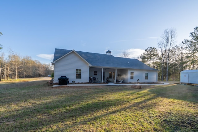 5761 Dixie Hwy, Rutledge, GA 30663 - rear view of property featuring a patio area, a lawn, a chimney, and roof with shingles