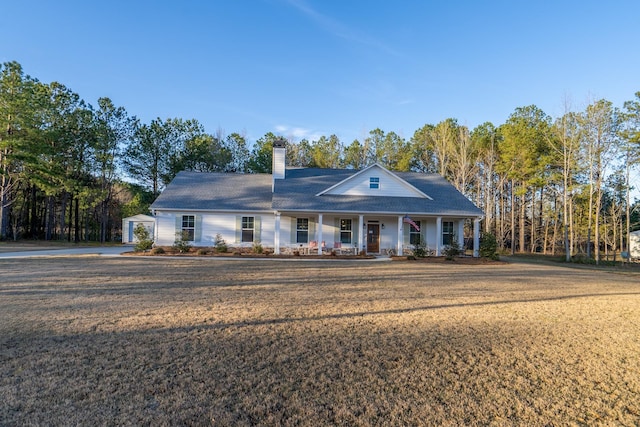 5761 Dixie Hwy, Rutledge, GA 30663 - view of front facade featuring a porch, a chimney, and a front yard