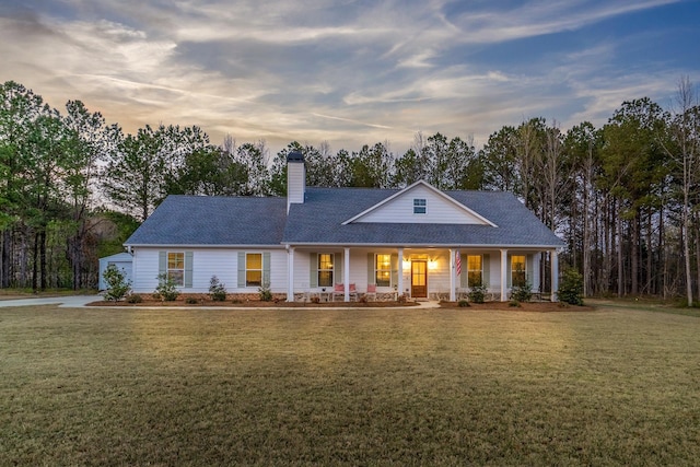 5761 Dixie Hwy, Rutledge, GA 30663 - view of front facade featuring a porch, a chimney, a front lawn, and roof with shingles