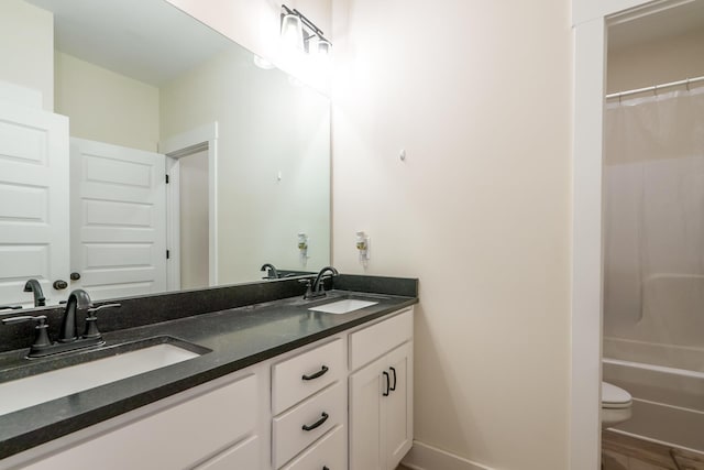 5761 Dixie Hwy, Rutledge, GA 30663 - bathroom with double vanity, toilet, baseboards, and shower / bath combo with shower curtain