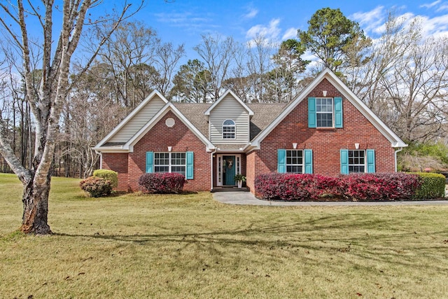 traditional home featuring a front lawn, brick siding, and roof with shingles