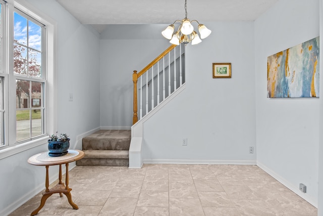 stairs with baseboards and a chandelier