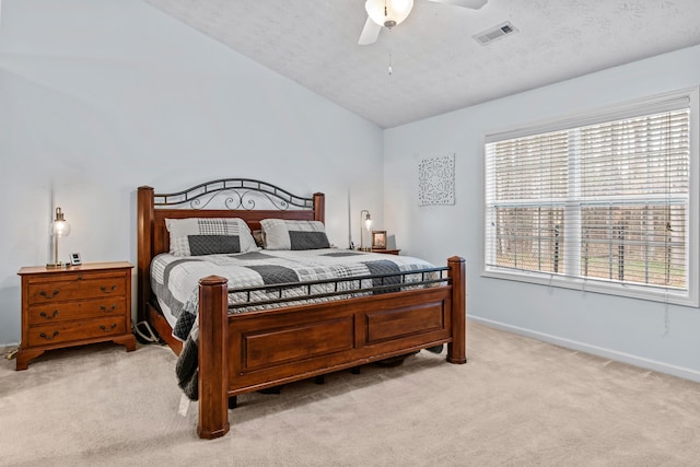 bedroom with visible vents, light carpet, lofted ceiling, a textured ceiling, and baseboards