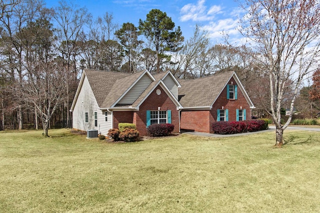 view of front of home with cooling unit, brick siding, a front yard, and a shingled roof