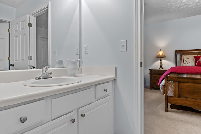 bathroom with vanity and a textured ceiling