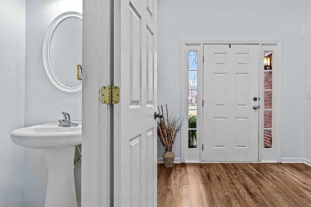 entryway with baseboards and wood finished floors