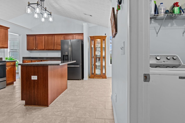 kitchen featuring fridge with ice dispenser, washer / clothes dryer, a kitchen island, stainless steel electric range, and lofted ceiling