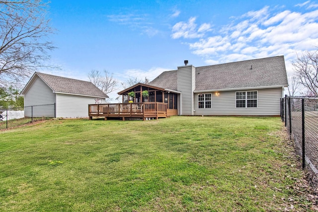 rear view of property featuring a fenced backyard, a yard, a sunroom, a wooden deck, and a chimney