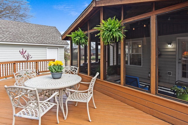 wooden deck with a sunroom