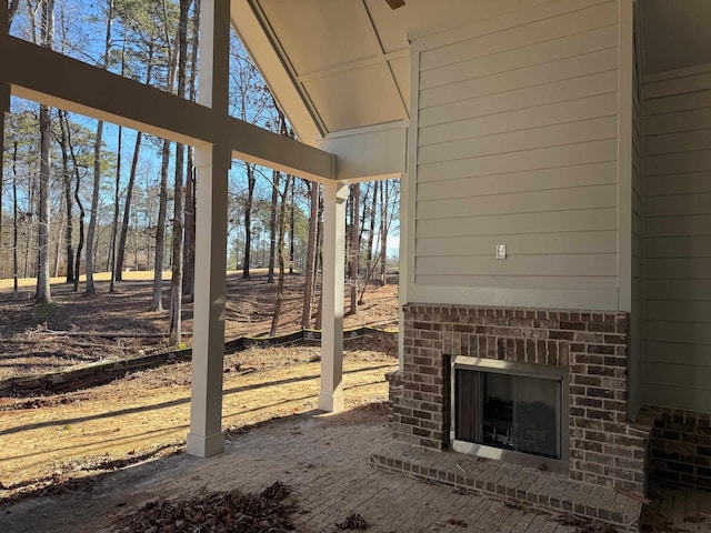 view of patio with an outdoor brick fireplace