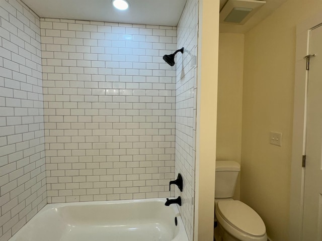 bathroom featuring toilet and tiled shower / bath combo